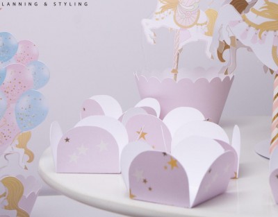 Caixas decorativas lilás e brancas com estrelas e balões ao fundo