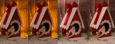 Caixa de presente em forma de casinha vermelha com laço, sobre neve artificial, fundo de luzes e madeira