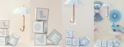 Cubos com letras formando LOVE, guarda-chuva branco suspenso e decoração azul clara