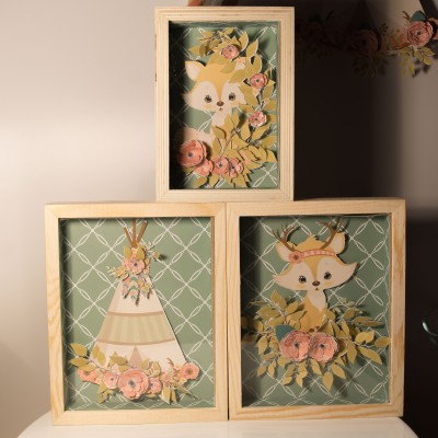 Três quadros de madeira com ilustrações em papel recortado de animais e flores