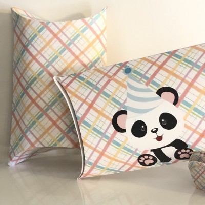 Travesseiros coloridos com padrão geométrico e panda cartoon com chapéu de festa