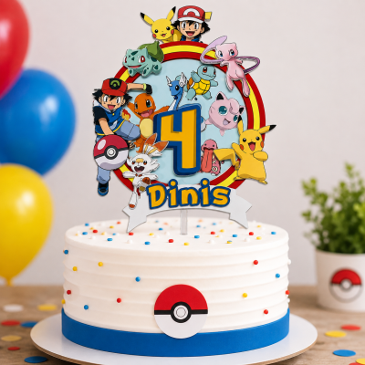 Bolo branco com decoração confetis coloridos e topo de bolo Pokémon com número 4 e nome Dinis