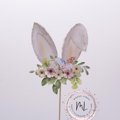Decoração com orelhas de coelho, flores, folhas e ovos em palito
