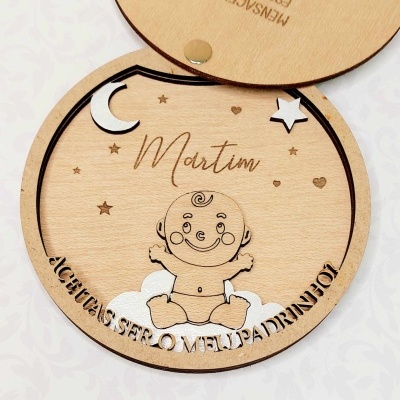 Caixa redonda em madeira clara com ilustração de bebé e texto gravado