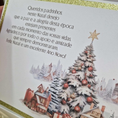 Cartão de Natal com texto e ilustração de árvore de Natal branca decorada e casas nevadas