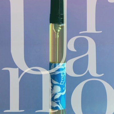 Transparent spray bottle with blue floral label and black cap