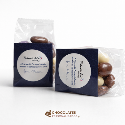 Ofertas de Páscoa para Empresas: Chocolates Personalizados que deixam marca Pacotes de chocolates variados com etiquetas personalizadas da France Air Portugal em fundo branco.