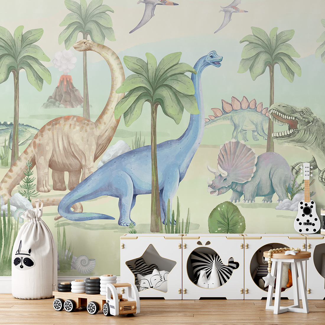 Papel de Parede Infantil Dinossauros Quarto infantil com papel de parede de dinossauros coloridos e móveis de arrumação brancos com espaços em formas decorativas.