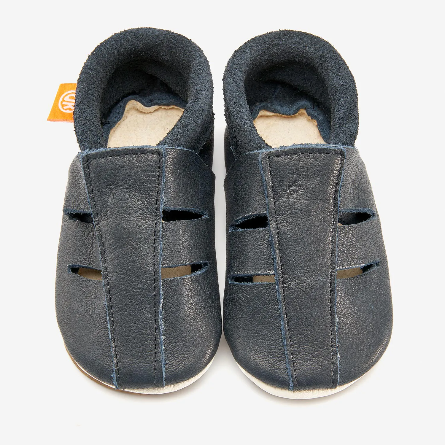 Sandália Infantil Azul Sapatinhos para bebé em pele azul escuro com interior forrado cinzento e etiqueta laranja.