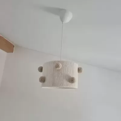 Lâmpada de tecto branca com pompons em ambiente interior