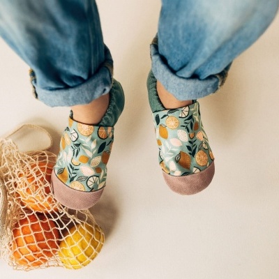 Sapatos infantis com padrão de frutas e calças de ganga dobradas