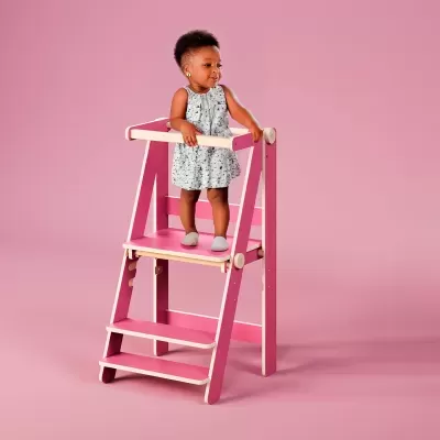 Escada de segurança infantil rosa com criança vestida de branco