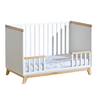 Berço infantis de madeira branco com detalhes em madeira clara e colchão acolchoado