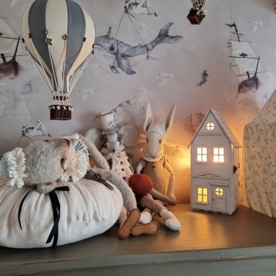 Decoração infantil com balões de ar quente, bonecos de pelúcia e casa luminosa