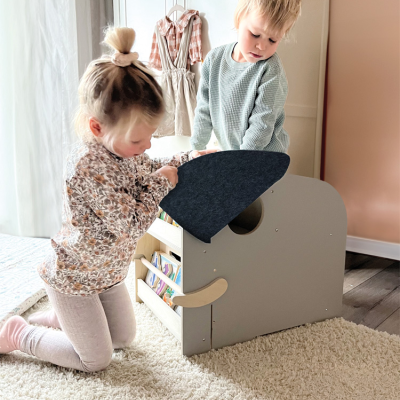 Crianças a brincar com baú de brinquedos cinza com tampa azul escura em quarto