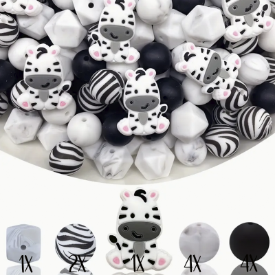 Contas de silicone variadas em branco, preto e padrões zebrais dentro de recipiente branco