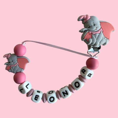 Chupeta personalizada com o nome LEONOR e figuras de Dumbo em silicone cinza e rosa.