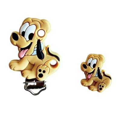 Dois acessórios em forma de cão amarelo com clip metálico numa peça.