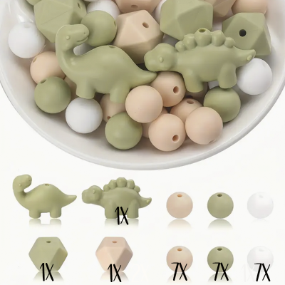 Contas de silicone com formas de dinossauro e contas redondas e hexagonais em verde, bege e branco.