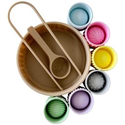 Conjunto de copos coloridos de silicone e utensílios em tigela beje