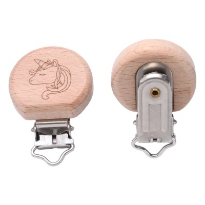 Prendedor redondo em madeira clara com unicórnio gravado e fecho metálico