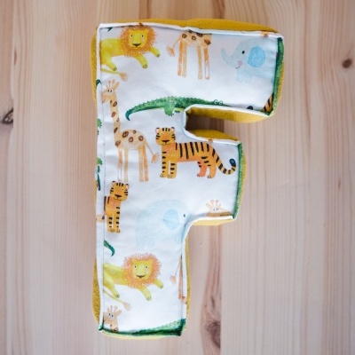 Letra de tecido com padrão de animais em madeira