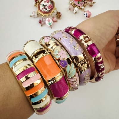 Pulseiras coloridas de metal e esmalte no braço