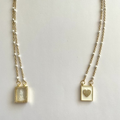 correntes douradas com pendentes quadrados, imagem religiosa e coração