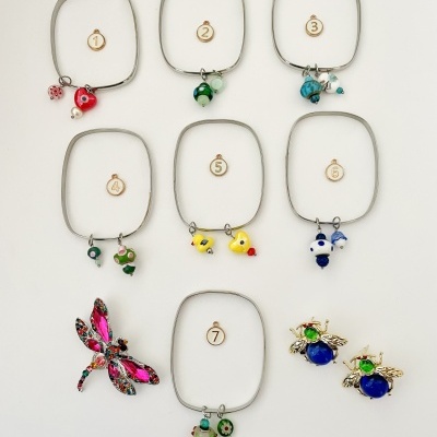 Pulseiras quadradas com pendentes de joaninhas, pássaros, abelhas e libélula em fundo branco