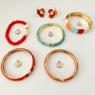 Conjunto de bijuterias coloridas numeradas de 1 a 5 sobre fundo branco