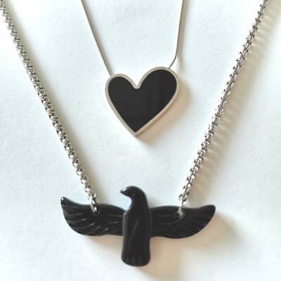 Colares com pendentes a forma de coração e pássaro, ambos pretos com correntes prateadas