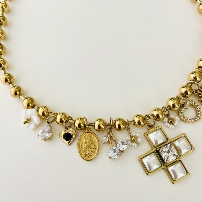 Colar dourado com pendentes variados incluindo flores, pedras e uma cruz com pedras.