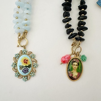 Dois colares com pendentes ovais e contas coloridas sobre fundo branco