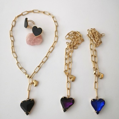 Colares e brincos com correntes douradas e pendentes em forma de coração em cristal preto, roxo e azul