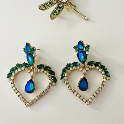 Brincos em forma de coração com pedras azuis e verdes e broche de libélula com pedras verdes e claras