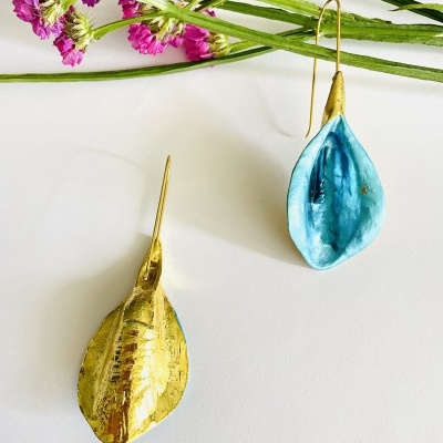 Brincos em formato de folha dourada e azul turquesa com gancho, e flores cor-de-rosa