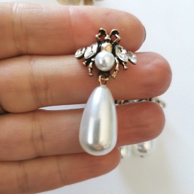 Brinco dourado com pérolas e cristais transparente pendurado