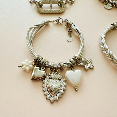 Pulseira prateada com pendentes em forma de coração, flor e textura metálica