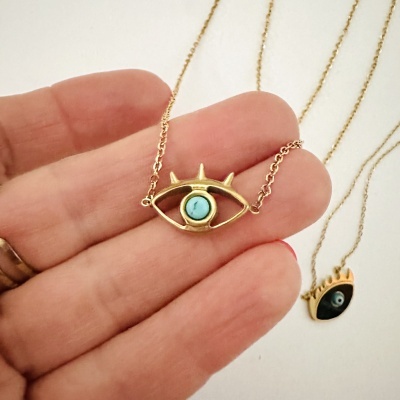 Colar dourado com pendente em forma de olho com pedra azul