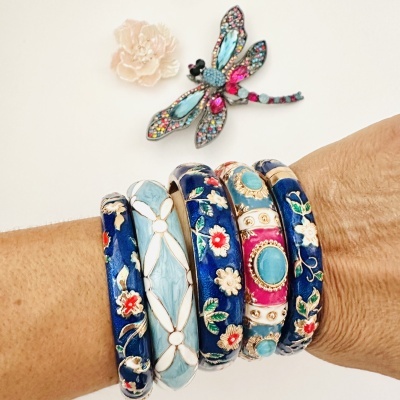 Pulseiras esmaltadas coloridas com padrões florais no pulso