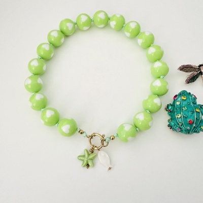 Pulseira verde com contas cerâmicas e pendentes de estrela do mar e peixe