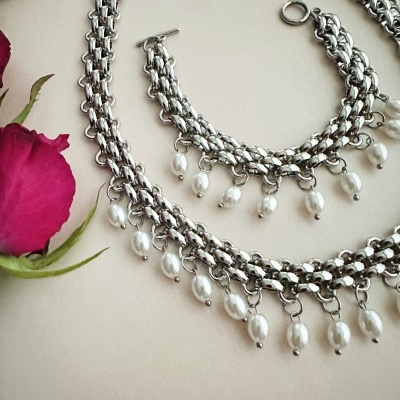 Conjunto de colar e pulseira prateados com pérolas e rosa vermelha