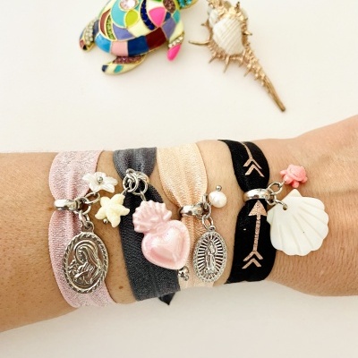 Pulseiras de tecido com vários pingentes no braço