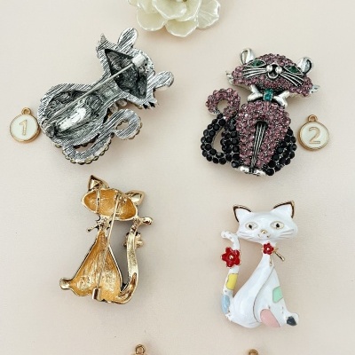 Quatro pins de animais em fundo bege claro, com marcadores numerados de 1 a 4