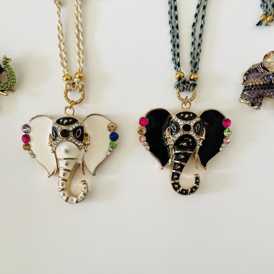Colares com pendentes em forma de elefante coloridos em metal e cordão trançado.