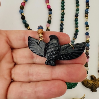 Colar de contas coloridas com pingente de pássaro preto brilhante