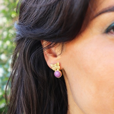 Brinco dourado borboleta com pedra roxa na orelha