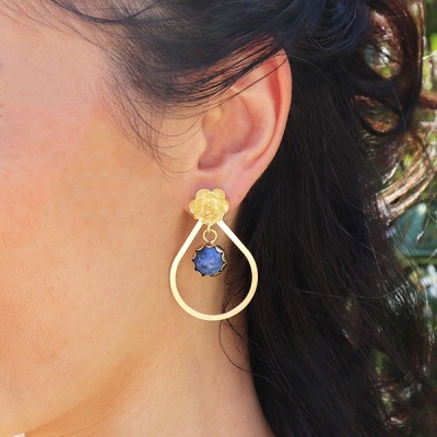 Brinco dourado com gota azul na orelha feminina