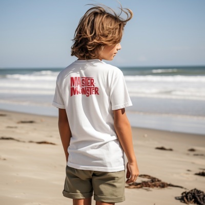 Camiseta branca com texto vermelho MASTER MONSTER nas costas de criança na praia.