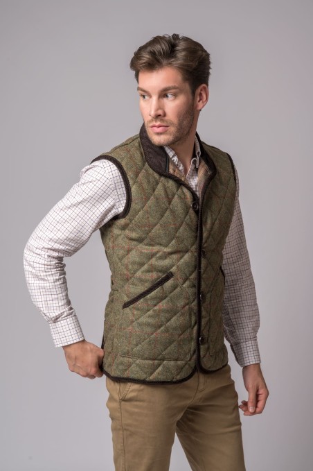 Homem com colete acolchoado verde e camisa xadrez branca